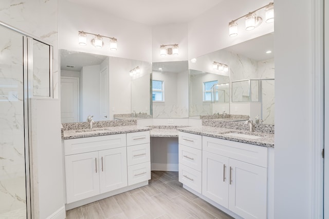 bathroom with vanity and an enclosed shower