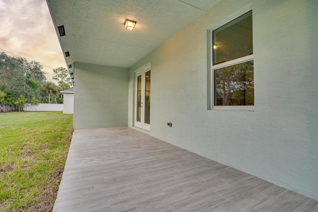 exterior space featuring french doors and a yard