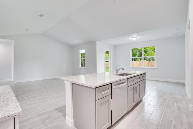 325 SW Majestic Ter, Port Saint Lucie, FL 34984 - kitchen with sink, gray cabinetry, light stone counters, stainless steel dishwasher, and a kitchen island with sink