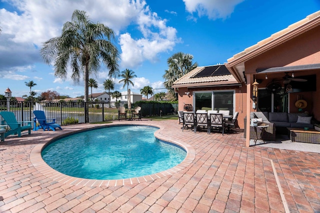 view of swimming pool with ceiling fan, outdoor lounge area, and a patio area