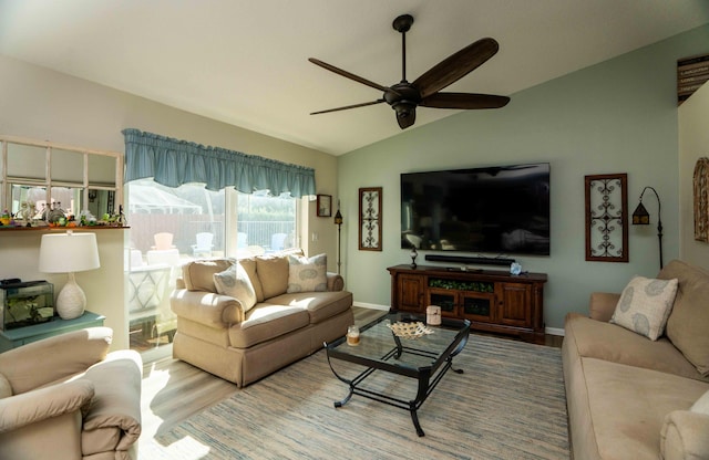 living room featuring lofted ceiling, hardwood / wood-style floors, and ceiling fan