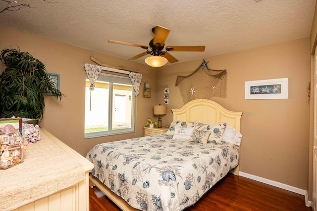 bedroom featuring ceiling fan, dark hardwood / wood-style flooring, and a textured ceiling