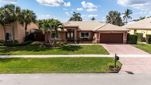 view of front of home with a garage and a front yard