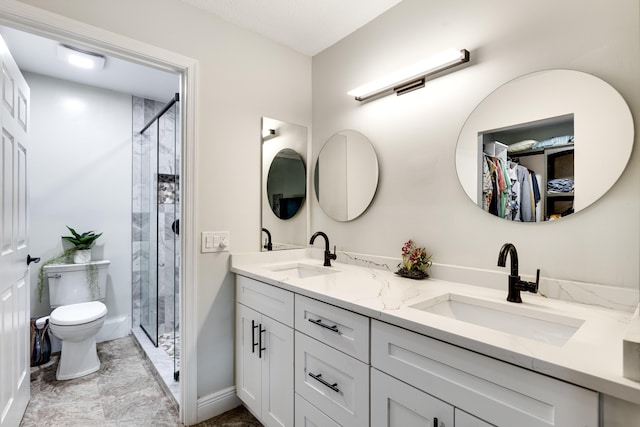 bathroom with vanity, toilet, and an enclosed shower