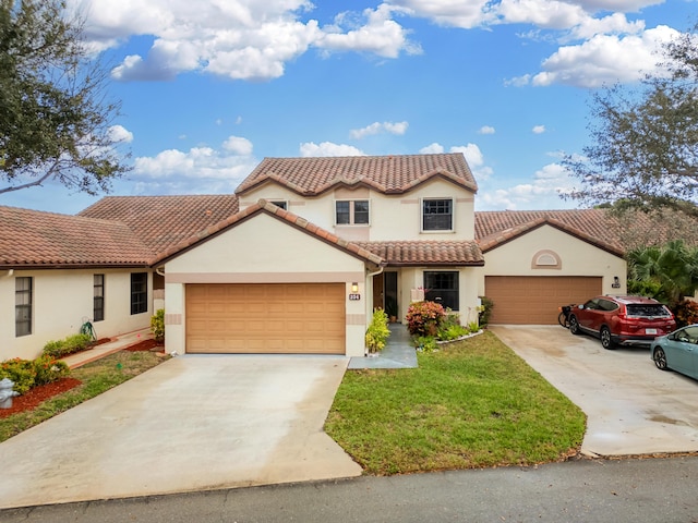 mediterranean / spanish-style house with a garage