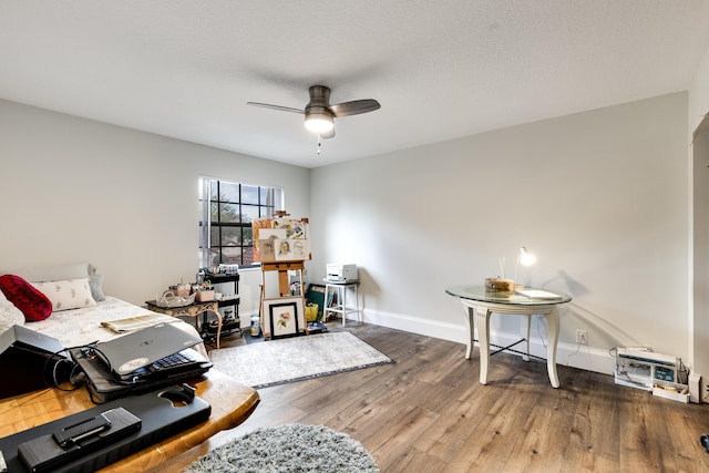 office area featuring hardwood / wood-style flooring, a textured ceiling, and ceiling fan