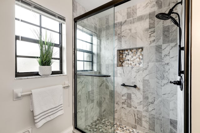 bathroom with a shower with shower door