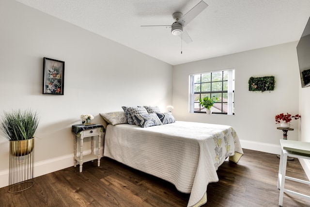 bedroom featuring ceiling fan, dark wood-type flooring, and a textured ceiling