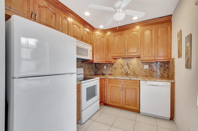 kitchen featuring a sink, decorative backsplash, white appliances, and light tile patterned flooring