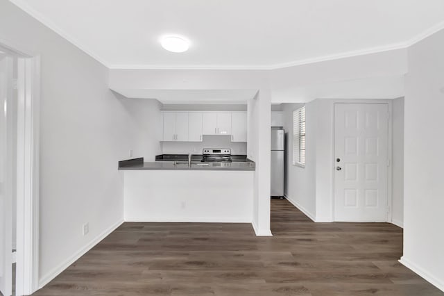 kitchen with sink, white cabinets, dark hardwood / wood-style flooring, ornamental molding, and stainless steel appliances