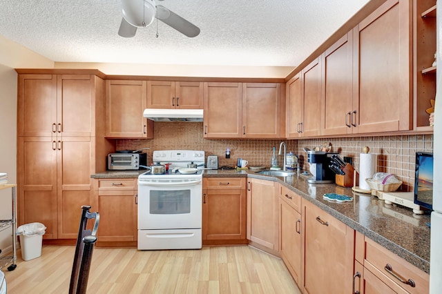 kitchen with tasteful backsplash, sink, dark stone counters, white electric range oven, and light wood-type flooring