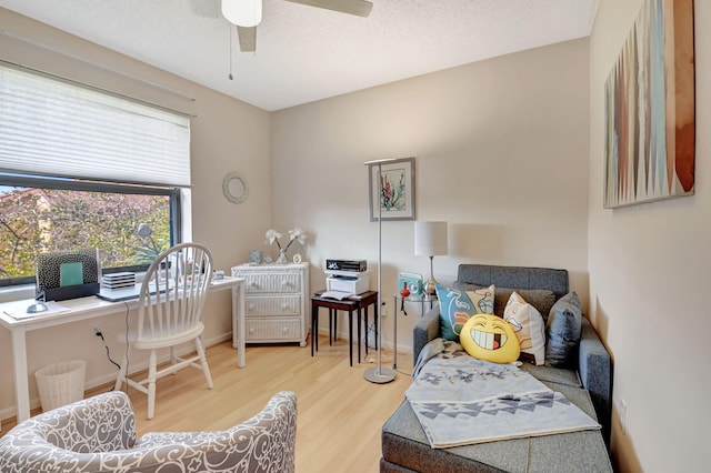 office area featuring ceiling fan, hardwood / wood-style flooring, and a textured ceiling