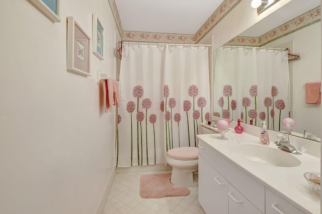 bathroom featuring walk in shower, vanity, and toilet