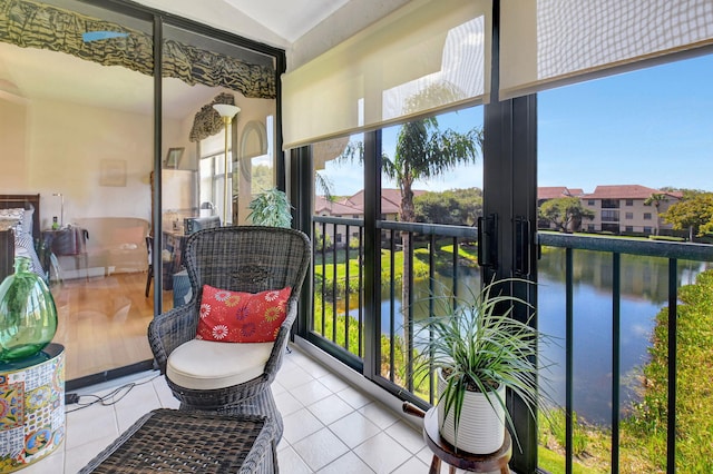 sunroom / solarium featuring a water view