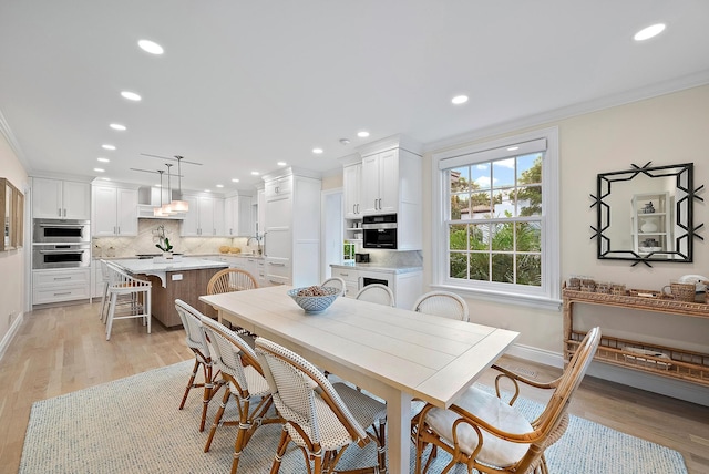 dining area with recessed lighting, light wood-type flooring, and crown molding