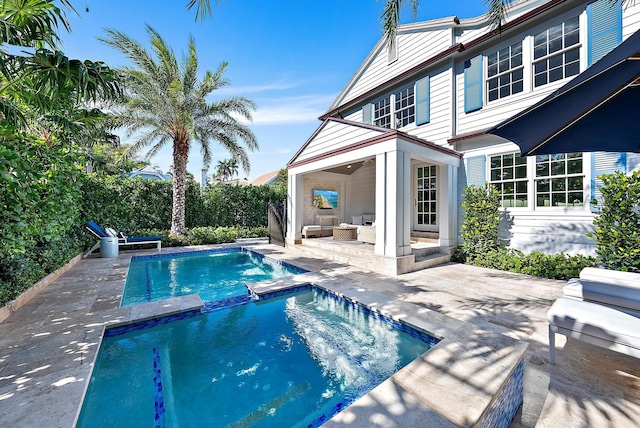 view of swimming pool with a patio, an outdoor hangout area, and a pool with connected hot tub