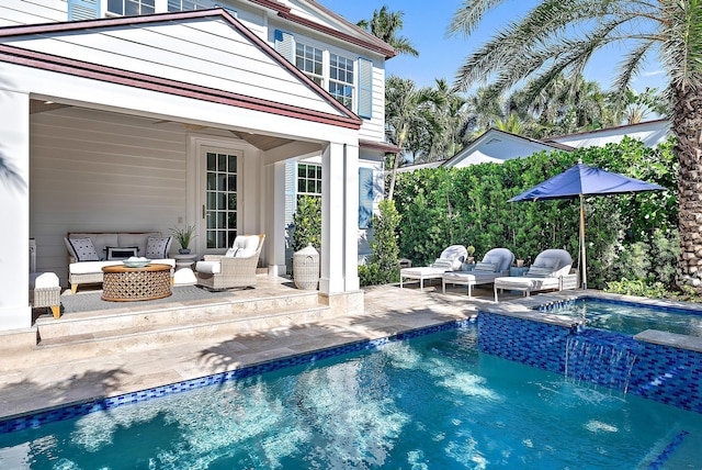 rear view of house featuring a pool with connected hot tub, an outdoor hangout area, and a patio