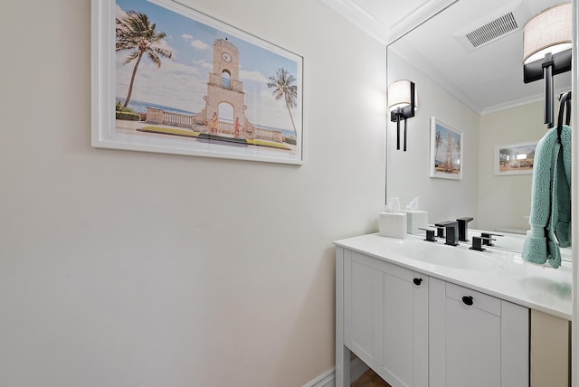 bathroom with vanity, visible vents, and crown molding