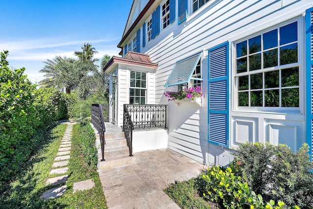 entrance to property featuring a standing seam roof and metal roof