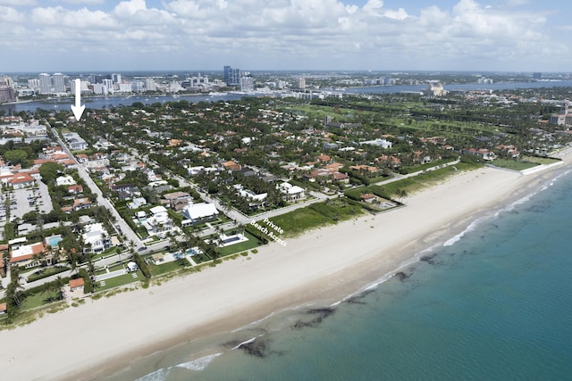 bird's eye view with a water view, a city view, and a view of the beach