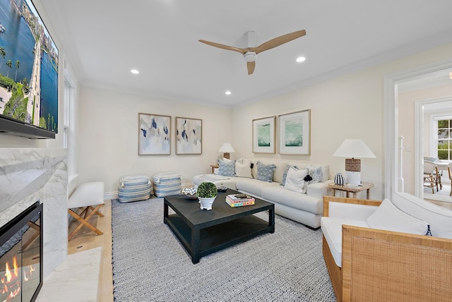 living room featuring recessed lighting, beverage cooler, a premium fireplace, wood finished floors, and a ceiling fan