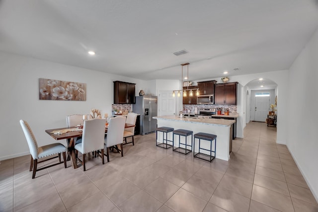 dining space featuring light tile patterned floors