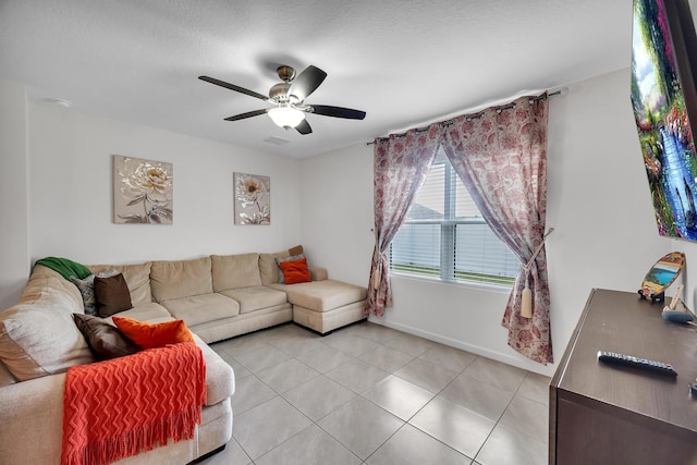 tiled living room featuring ceiling fan and a textured ceiling