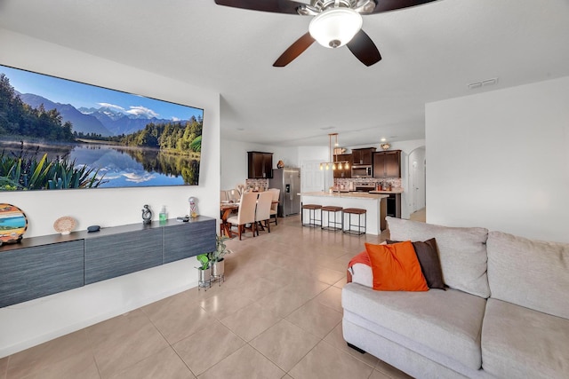 living room with light tile patterned floors and ceiling fan