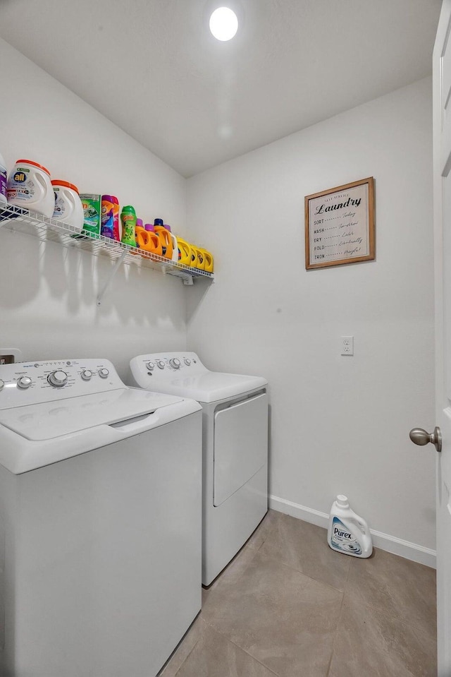 clothes washing area with light tile patterned floors and washing machine and dryer