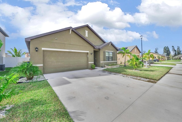 view of front of home featuring a garage, central air condition unit, and a front lawn