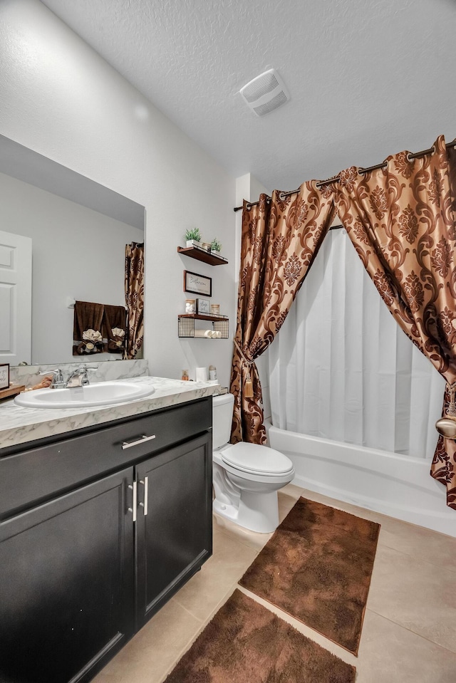 full bathroom featuring shower / bath combo, tile patterned flooring, vanity, a textured ceiling, and toilet