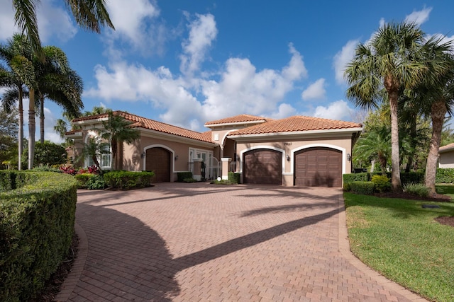 mediterranean / spanish home featuring a garage