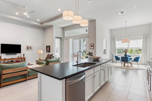 kitchen with sink, hanging light fixtures, white cabinets, a center island with sink, and stainless steel dishwasher