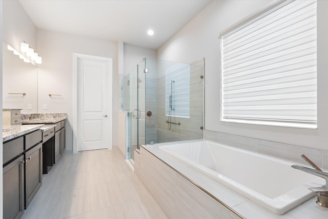 bathroom featuring vanity and plus walk in shower