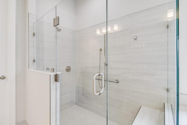 bathroom featuring a shower with door