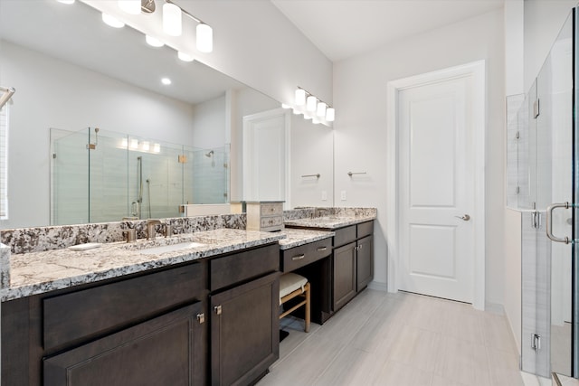 bathroom featuring walk in shower and vanity