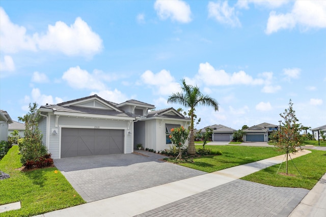 view of front of property featuring a garage and a front lawn