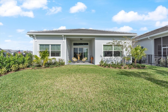 rear view of property with a yard