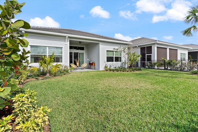 rear view of property with a lawn