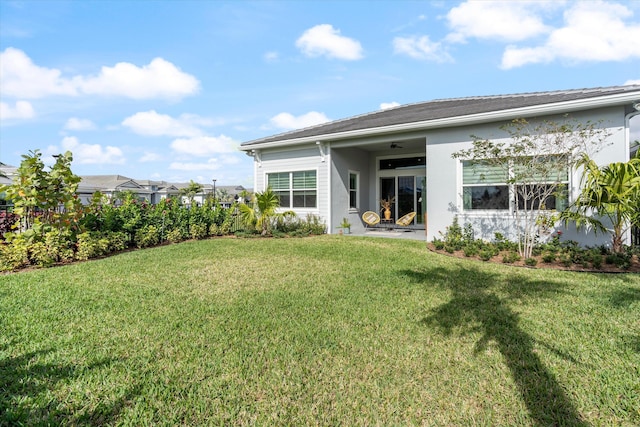 rear view of house featuring a lawn