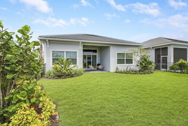 back of property featuring a patio area and a lawn