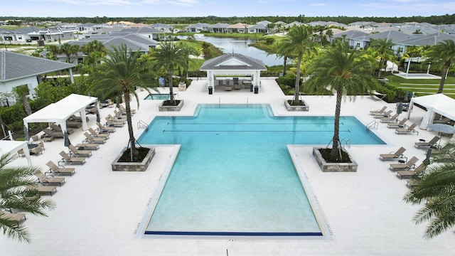 view of pool featuring a gazebo, a patio area, and a water view