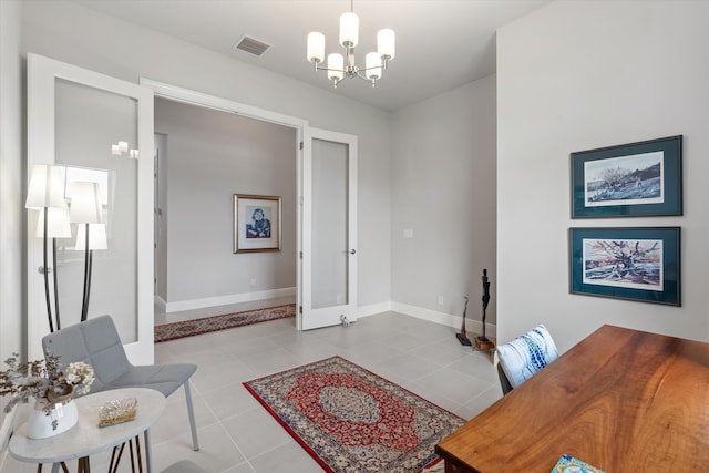 office space with an inviting chandelier and light tile patterned floors