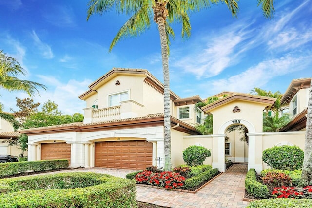 mediterranean / spanish-style home with a garage