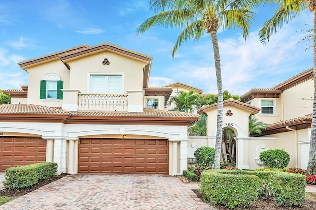 mediterranean / spanish-style house with a garage