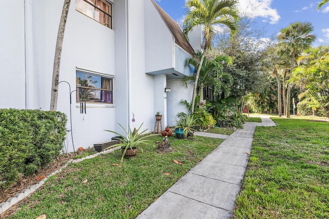 view of property exterior featuring a lawn