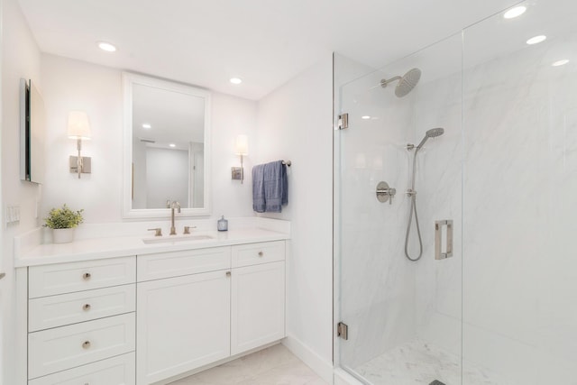 bathroom featuring vanity and a shower with shower door