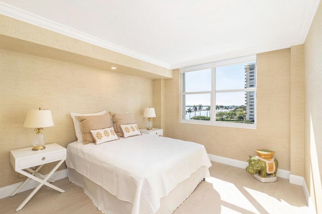 bedroom featuring crown molding and light hardwood / wood-style flooring