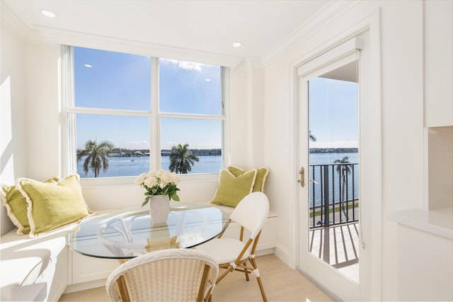 sitting room with ornamental molding and a water view