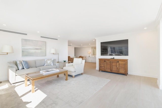 living room with crown molding and light hardwood / wood-style flooring